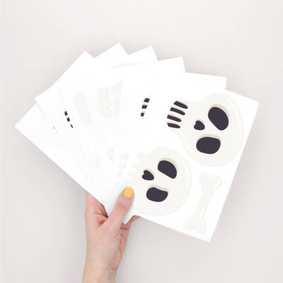 A hand holding skull wall stickers
