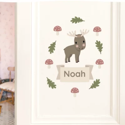Door decorated with a name sign reading “Noah”, illustrated with a moose and forest details.