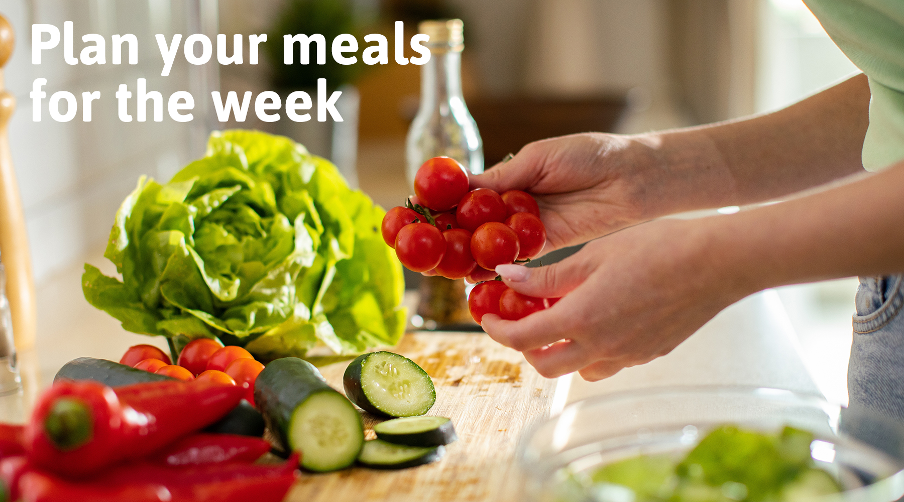 Fresh vegetables being prepared on a kitchen counter with the text Plan your meals for the week in the background. Perfect for promoting kitchen organization and healthy living tips.