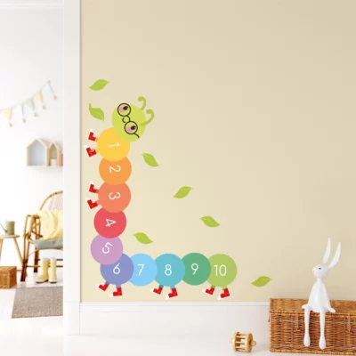 Colorful caterpillar wall decal with numbers for children's room decor.