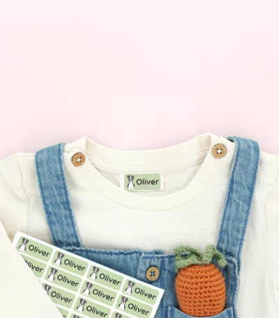 Personalized name labels in a child's denim outfit pocket, accompanied by trendy shoes. Perfect for organizing children's clothing and belongings. Ideal for parents seeking name tags and stylish accessories for kids.