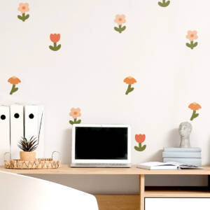 Charming floral wall decals adorn a child's room, creating a playful and inviting atmosphere. The decor features colorful flowers on a light background, perfect for personalizing your child's space. Enhance your child's room with our unique wall decorations, designed to inspire creativity and joy.