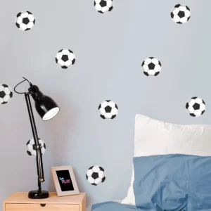 A playful children's bedroom featuring wall decor with soccer ball stickers, complemented by a bedside lamp and a picture frame displaying a colorful 'Let's Play' design. Perfect for creating an energetic and fun atmosphere for young soccer fans.