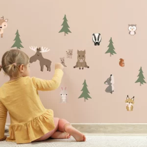 Child engaging with playful animal wall decals in soft colors, enhancing a cozy children's room atmosphere. Ideal for decorating nursery spaces and creating a whimsical environment with unique wall decor.