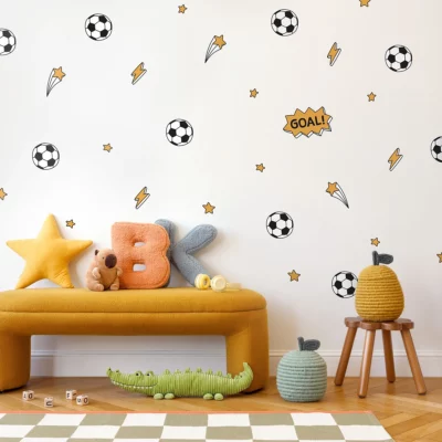 Bright and playful children's room featuring wall decor with soccer ball designs, stars, and fun phrases. A cozy yellow bench displays colorful plush toys and decorative pillows, creating an inviting atmosphere for kids. Ideal inspiration for unique children's wall art and home decor. Perfect for birthday celebrations, enhancing creativity in children's spaces.